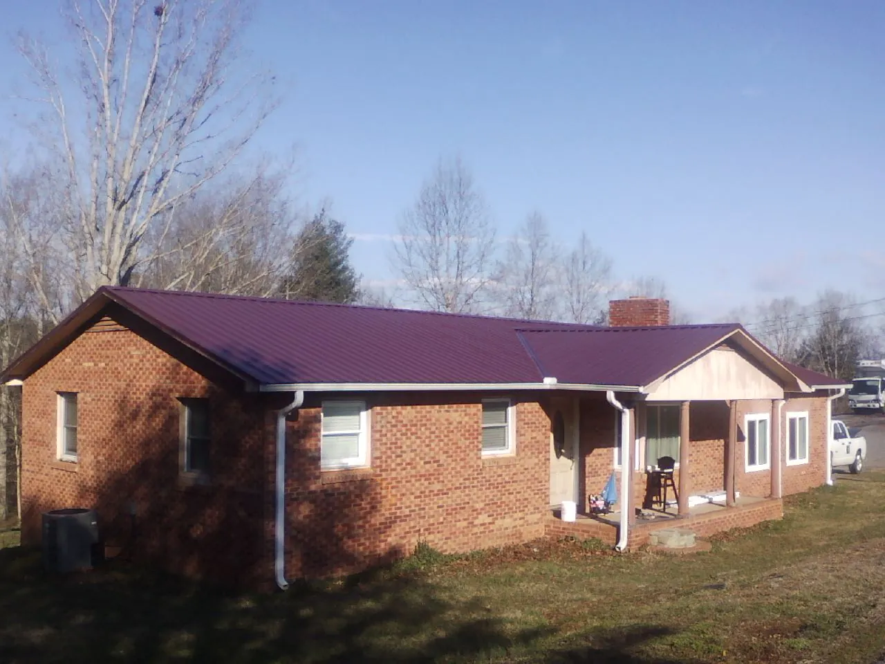 Burgundy metal roof on a brick ranch home with a new addition in Sharpsburg