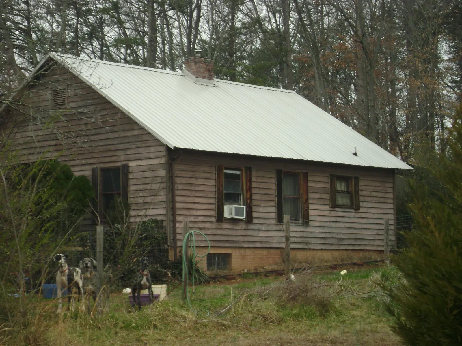 White metal roof on an old wood sided farmhouse, from a Metal Roof Installation job in Sharpsburg